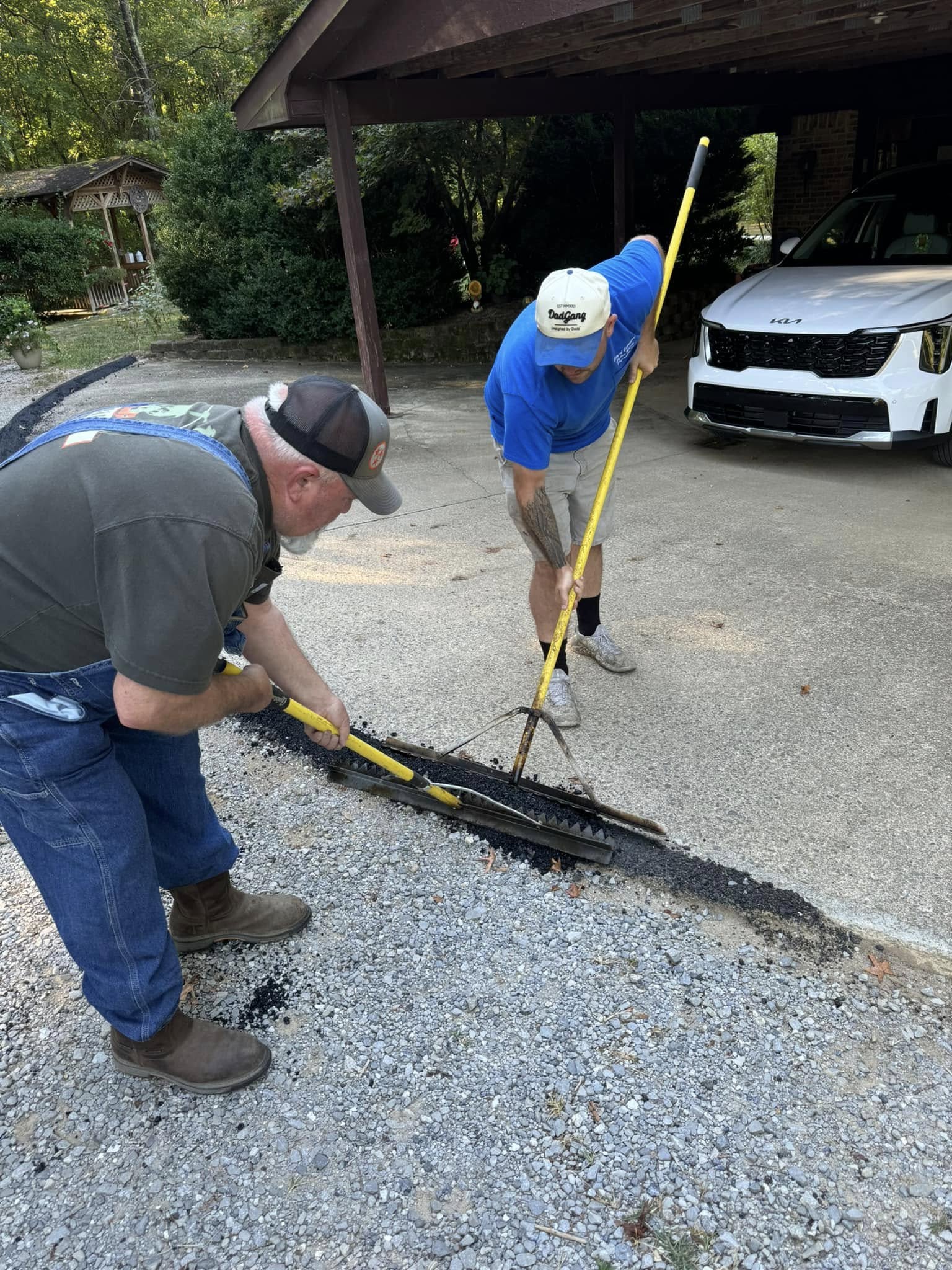 Workers applying asphalt repair